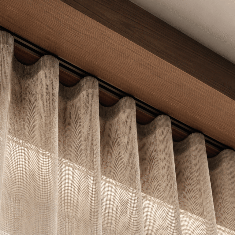 Close-up of sheer linen curtains beneath a timber pelmet, highlighting soft natural light and detailed interior craftsmanship.
