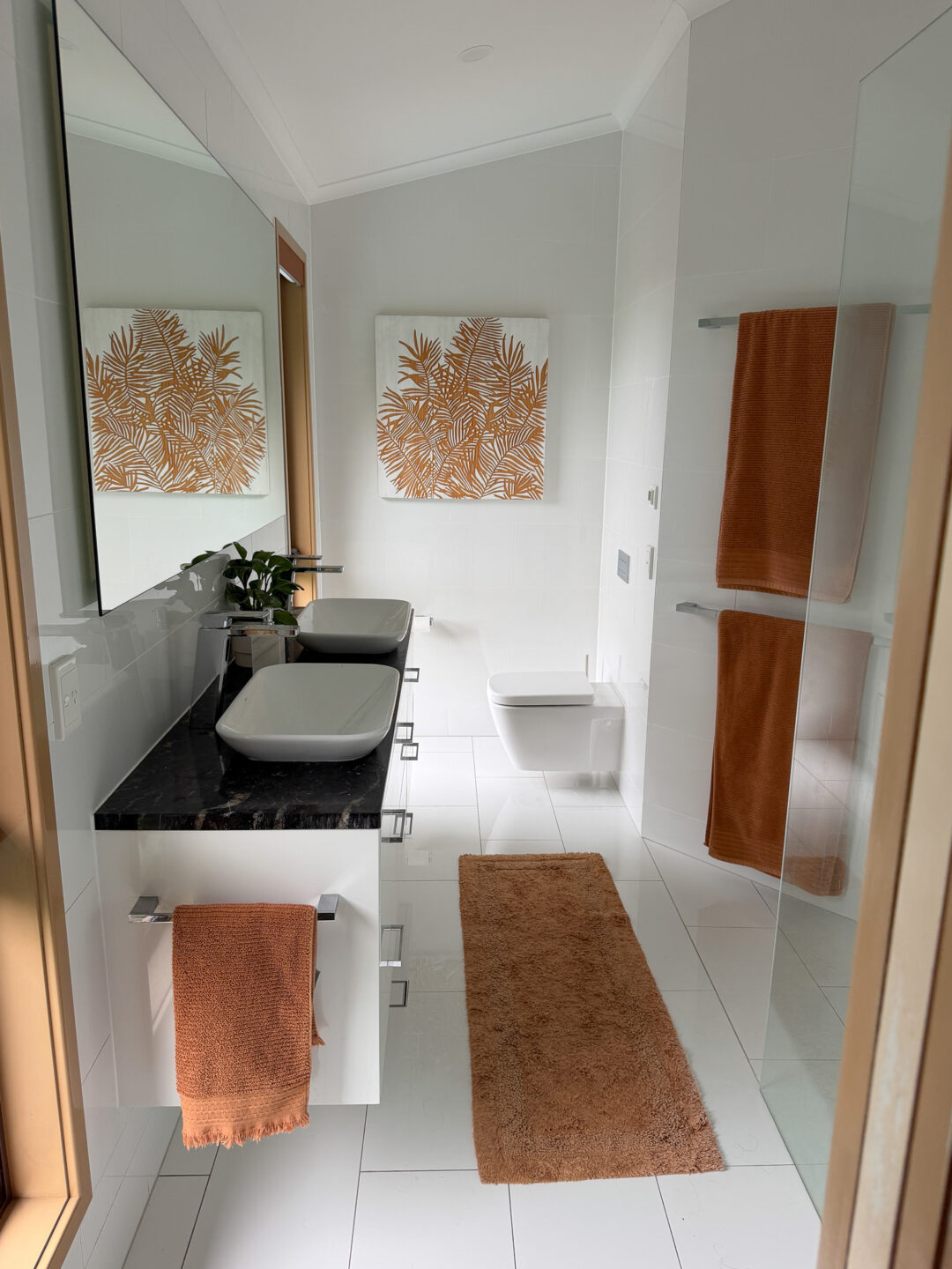Bright bathroom renovation with freestanding bath, walk-in shower, timber vanity and warm neutral finishes.